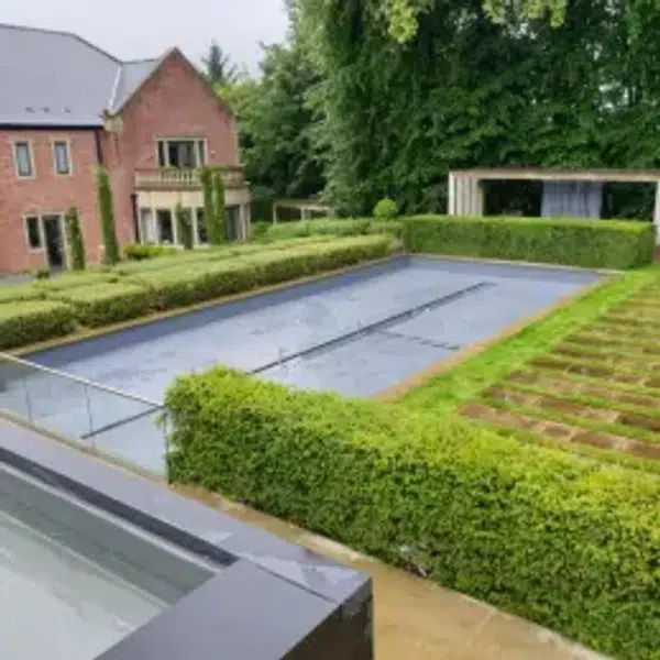 "A seamless liquid roofing membrane being applied with a roller on a flat roof surface."