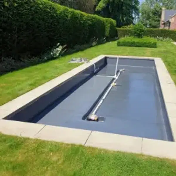 "Close-up of a liquid roofing membrane curing under sunlight, offering UV and weather protection."